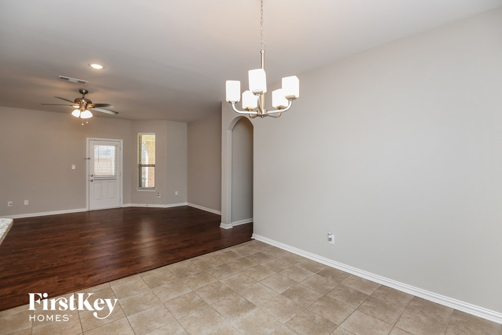 the living room and dining room with the entryway to the kitchen