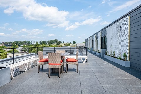 a patio with tables and chairs on a roof