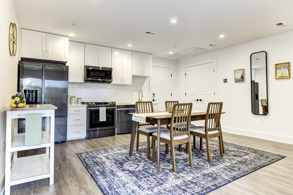 a kitchen and dining room with a table and chairs