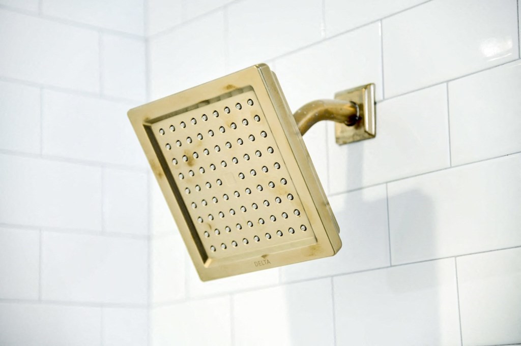 a close up of a shower head in a bathroom