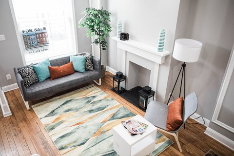 a living room with a couch and a table and a fireplace