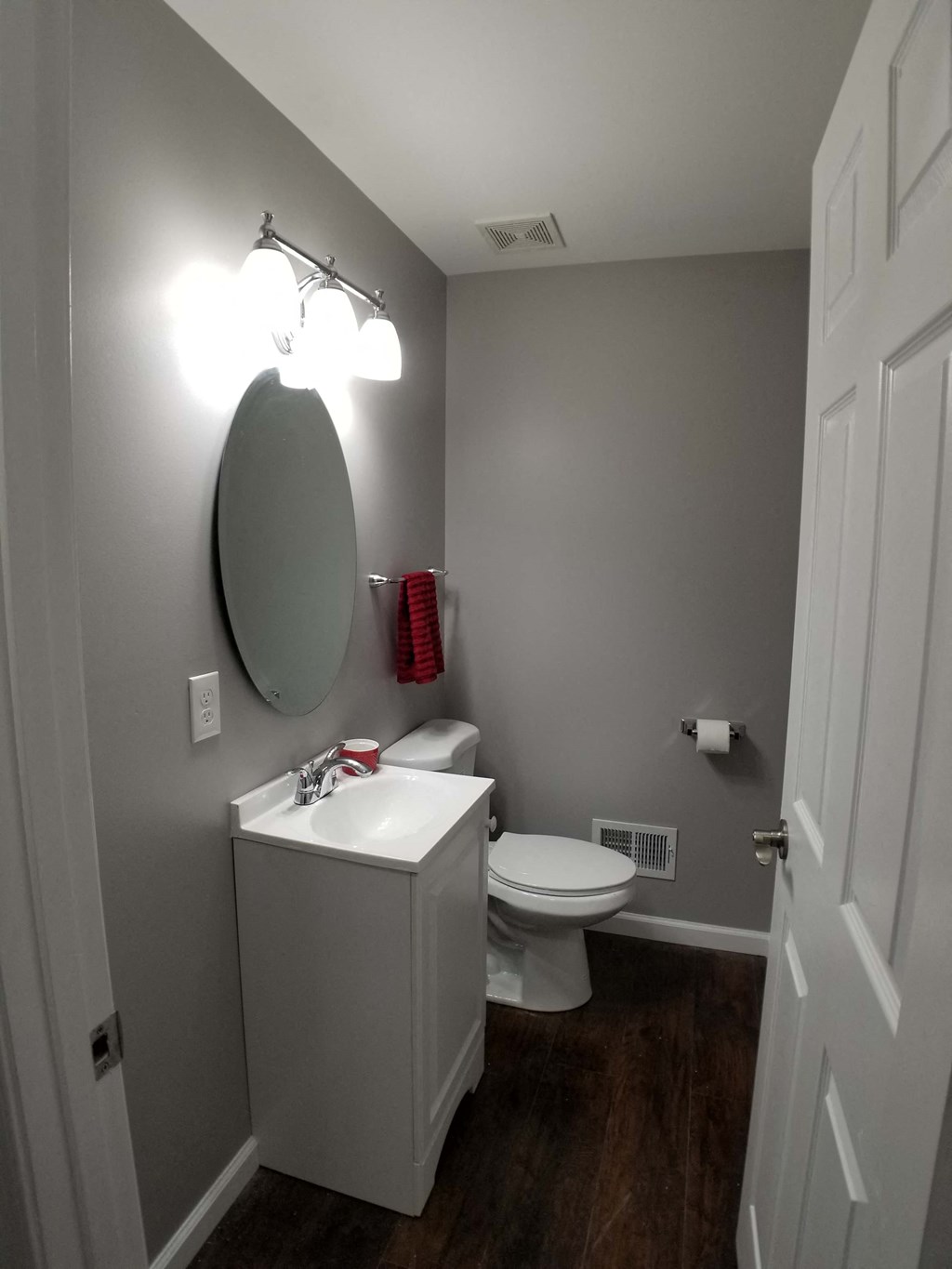 a bathroom with a toilet and a sink and a mirror