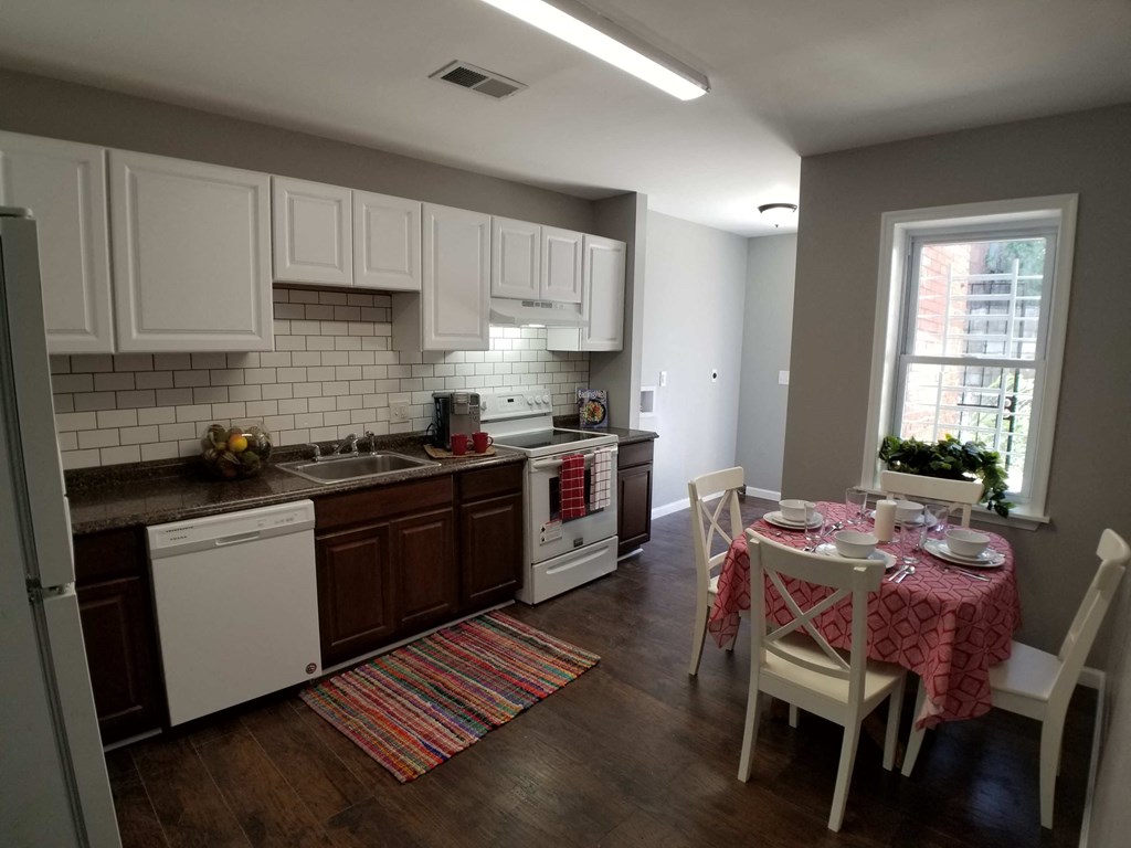 a kitchen and dining room with a table and chairs