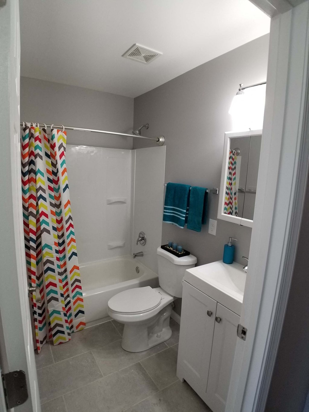 a small bathroom with a shower toilet and sink