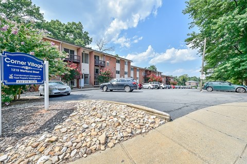 a street corner with a blue sign that reads corner village