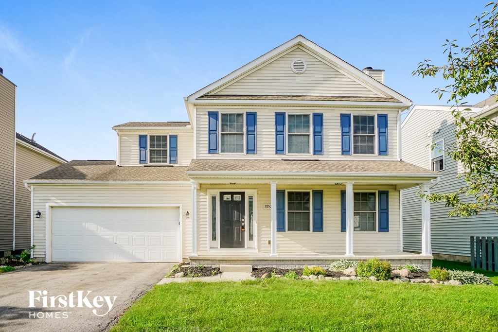 A two-story house with a garage and a front porch.