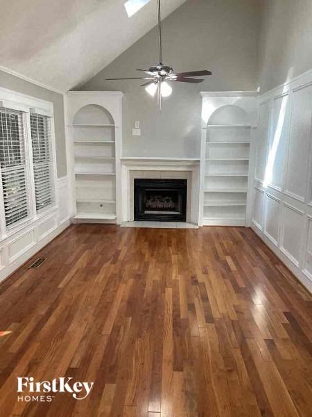 a living room with a hard wood floor and a fireplace