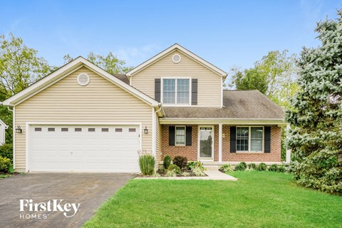 A two-story house with a garage is for sale.