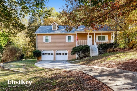 a house with two garage doors and a driveway
