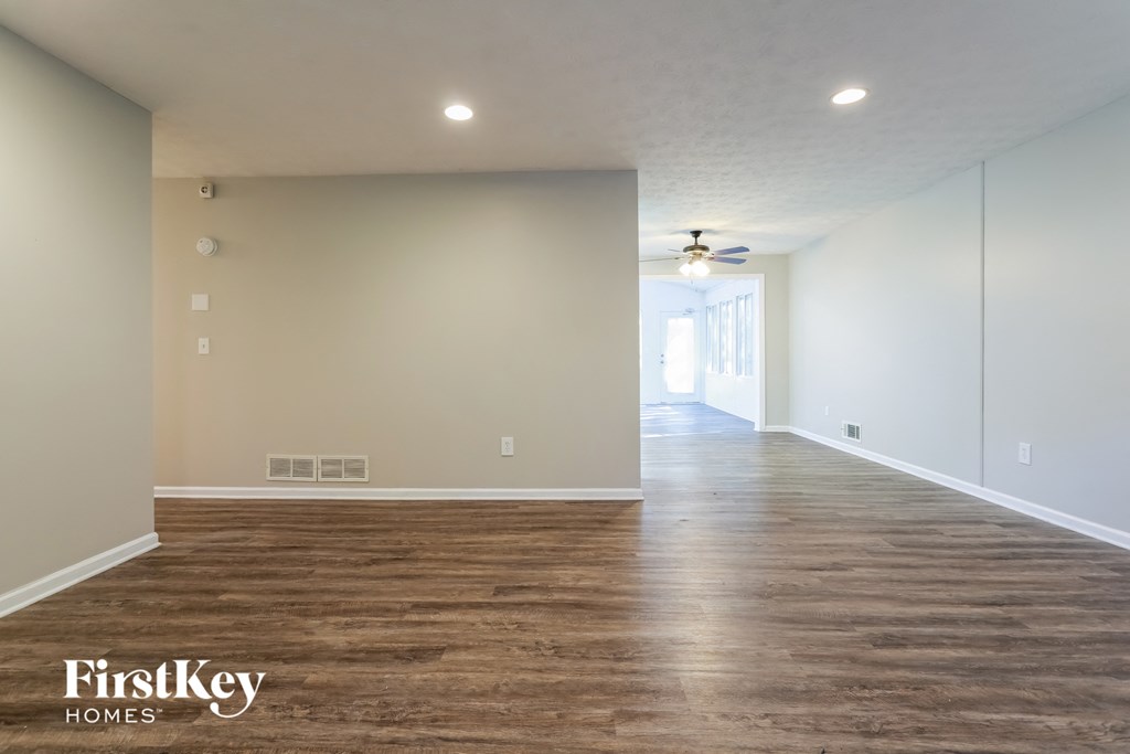the living room and dining room of an empty house