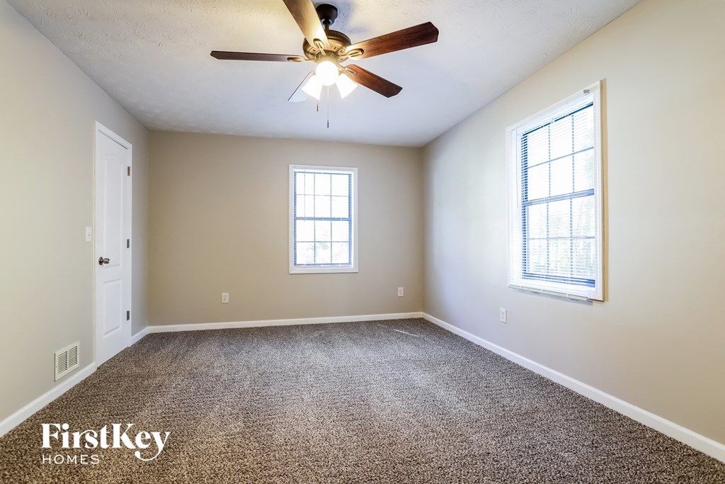 the master bedroom is spacious and has a ceiling fan