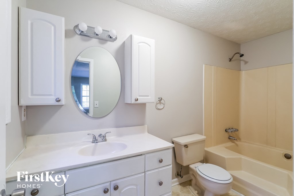 a bathroom with a sink toilet and a bath tub