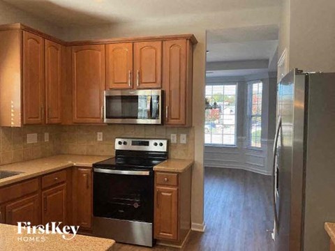A kitchen with wooden cabinets and stainless steel appliances.