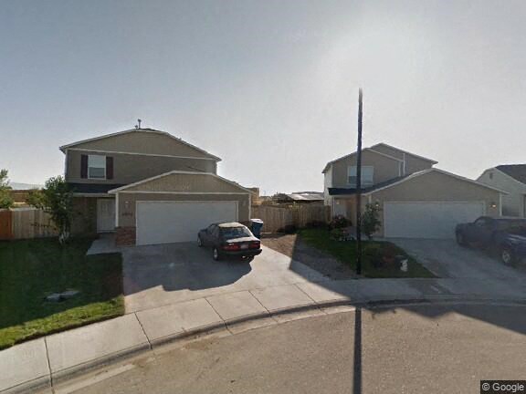 A car is parked in front of a house.