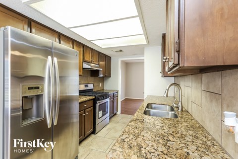 a kitchen with stainless steel appliances and granite counter tops