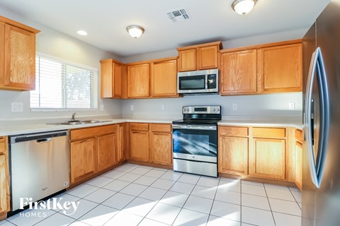 a kitchen with wooden cabinets and stainless steel appliances