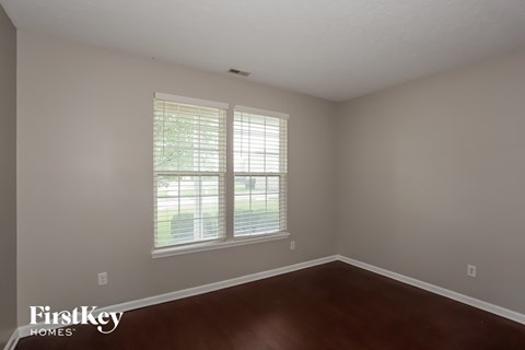 a living room with wood floors and a large window