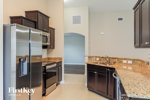 a kitchen with granite counter tops and stainless steel appliances