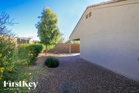A gravel path leads to a white building with a FirstKey HOMEC sign.