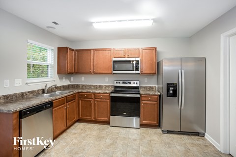 a kitchen with wooden cabinets and stainless steel appliances