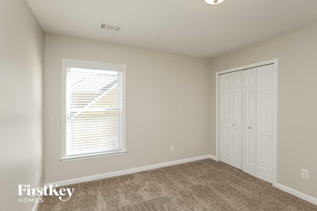 A room with a window and a door is shown.