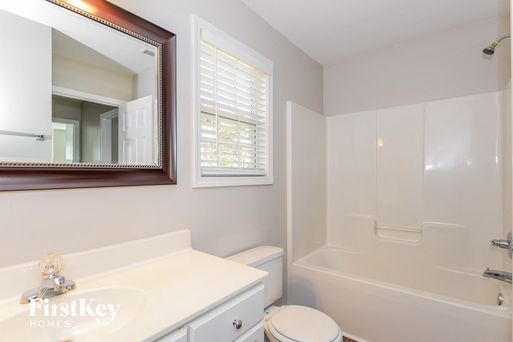 a bathroom with a sink and a toilet and a bath tub