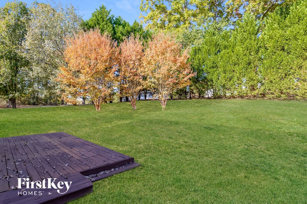 a picnic table in the middle of a grass field