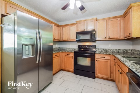 a kitchen with wooden cabinets and stainless steel appliances
