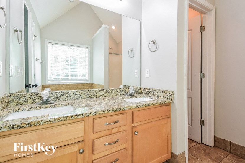 a bathroom with two sinks and a large mirror