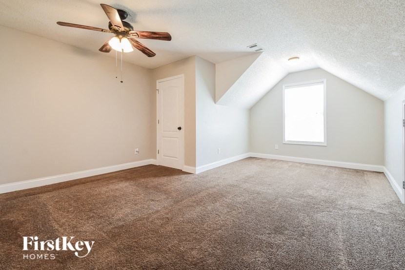 the master bedroom is spacious and has a ceiling fan