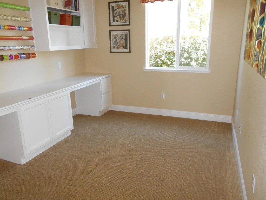 a room with a desk and a window