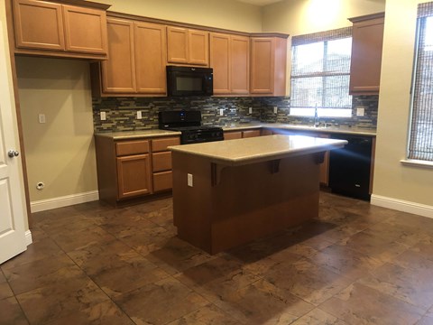a kitchen with wooden cabinets and a counter top