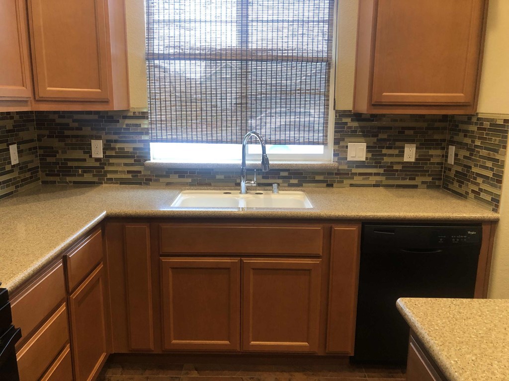 a kitchen with a sink and a window