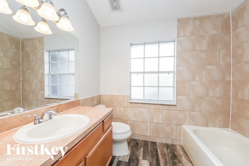 a bathroom with a sink and a toilet and a tub