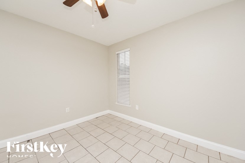 a empty living room with a ceiling fan