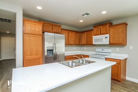 A kitchen with wooden cabinets and a white countertop.