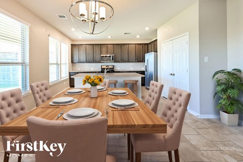 A dining room with a wooden table set for six.