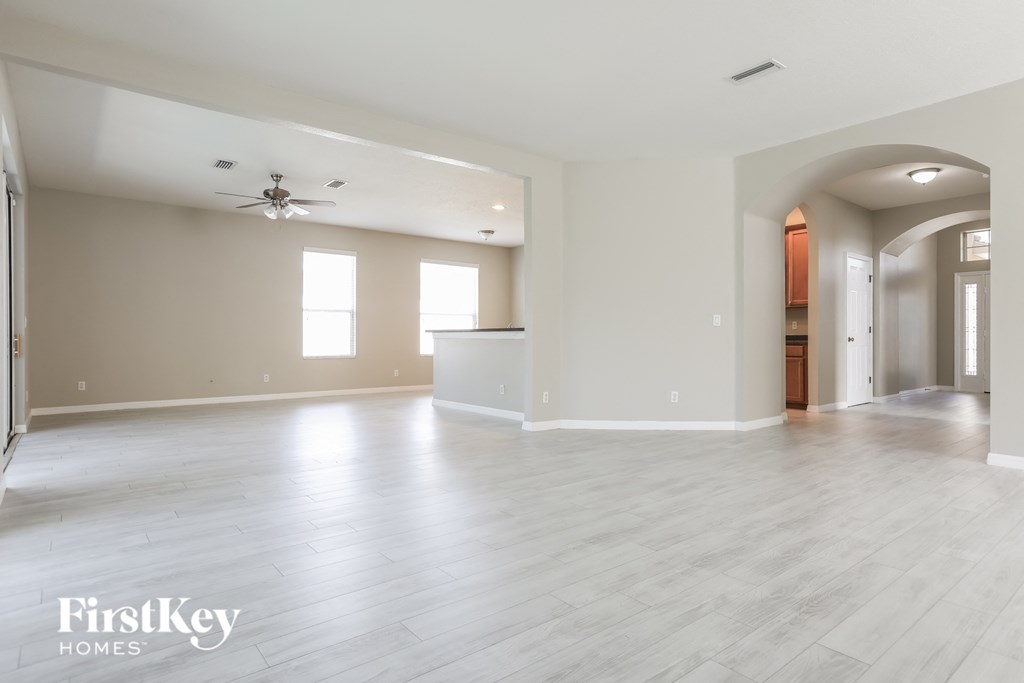 the living room and dining room with the kitchen in the background