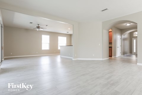 the living room and dining room with the kitchen in the background