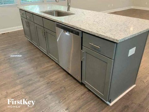 A kitchen with a sink and a dishwasher.