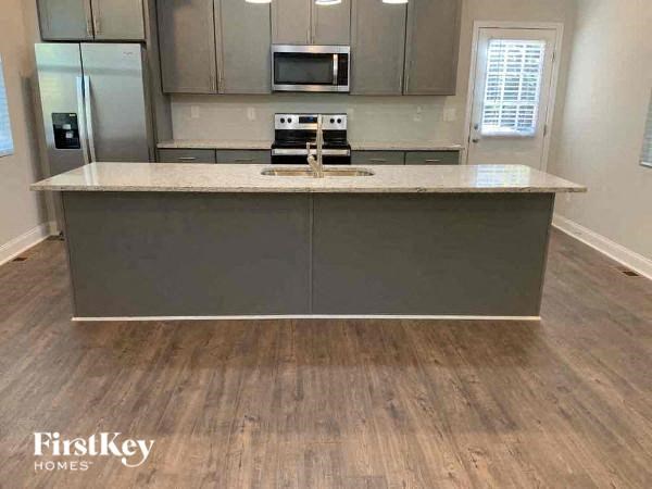 A kitchen with a wooden floor and a countertop.