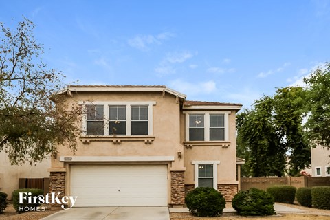 a beige house with a white garage door