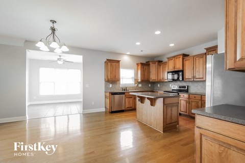 an open kitchen with wooden cabinets and stainless steel appliances