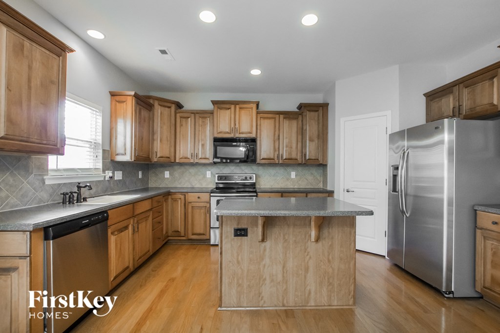 a kitchen with wooden cabinets and stainless steel appliances
