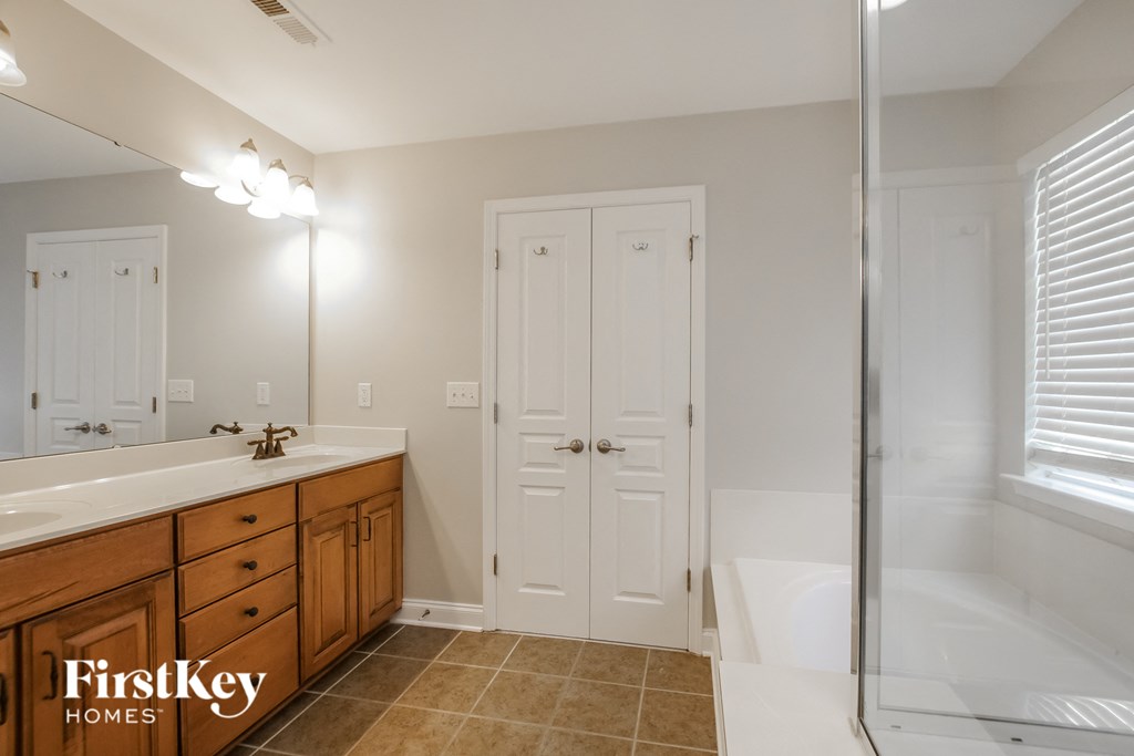 a bathroom with a sink and a tub and a shower
