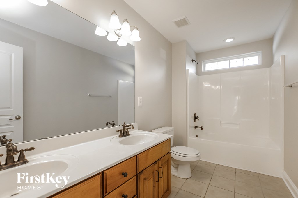 a bathroom with a sink and a toilet and a shower
