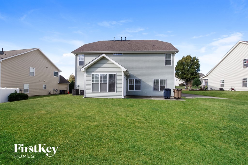 a white house with a yard in front of it