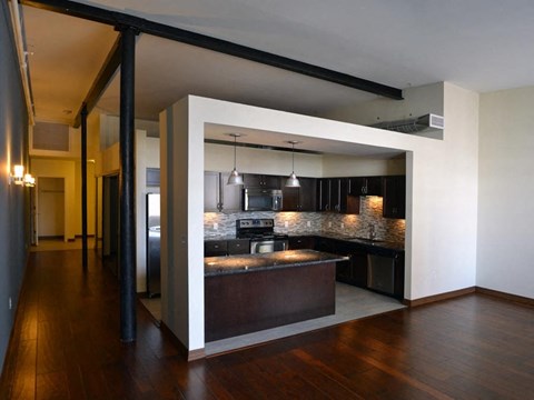 a kitchen with an island in the middle of a living room
