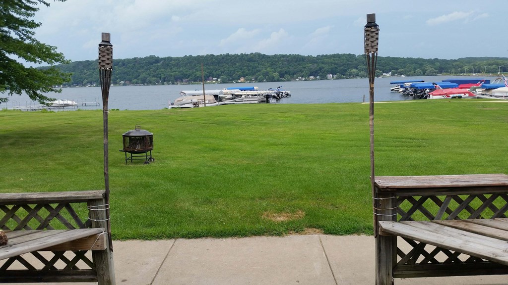 a view of the lake from a patio with benches