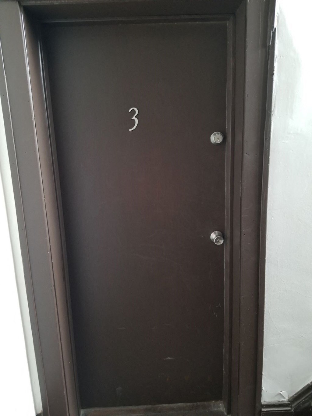 a brown door with the number 3 on it